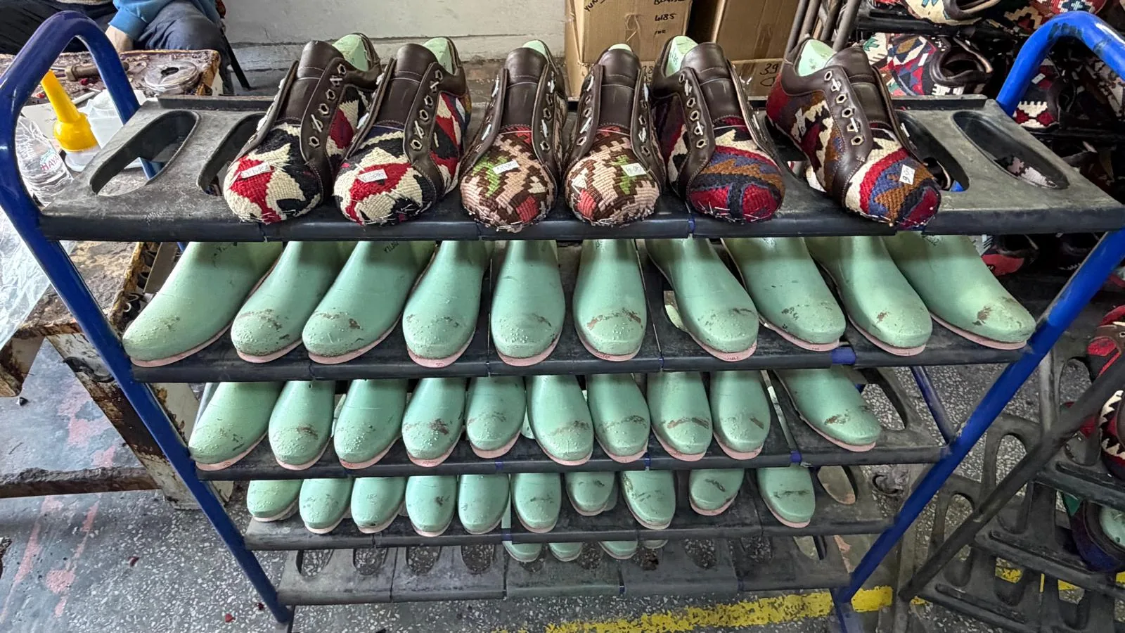 Wooden lasts and lasted kilim shoes lined up at the YUNART atelier