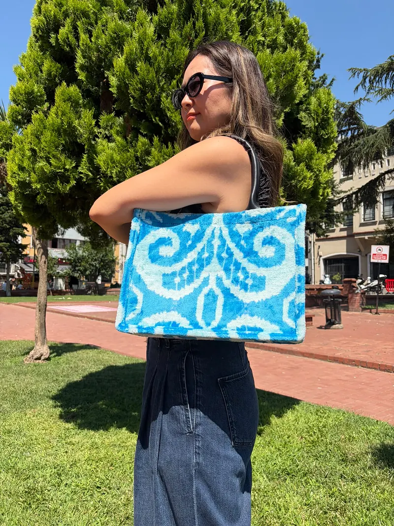 The blue ikat tote resting against the hip