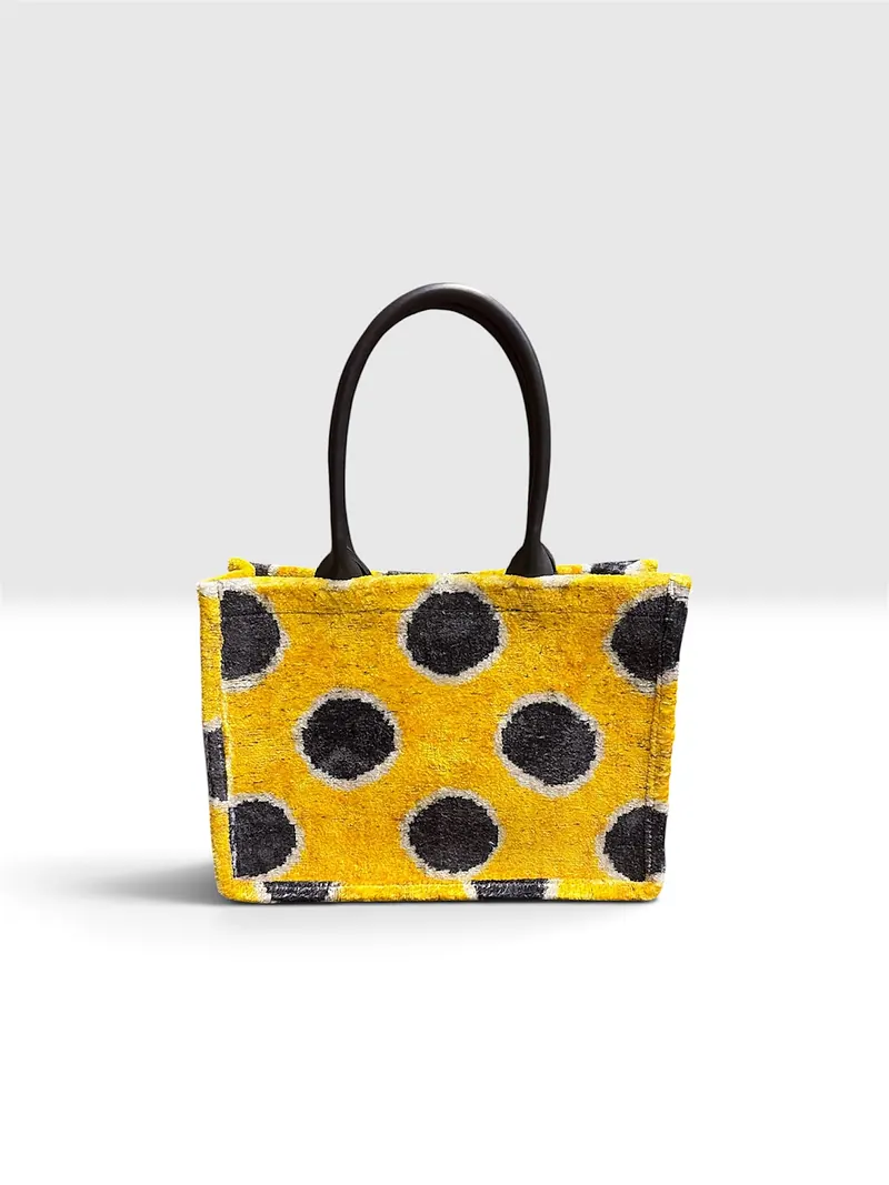 The same tote seen straight on against a plain ground, its full width visible