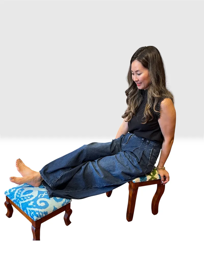 Sitting with legs stretched onto a stool, showing its height